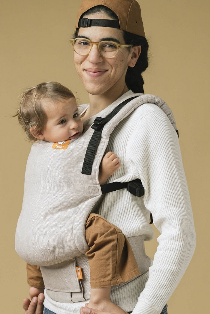 Opiekun nosi dziecko w nosidełku Tula Linen Free-to-Grow z lnu i czesanej bawełny